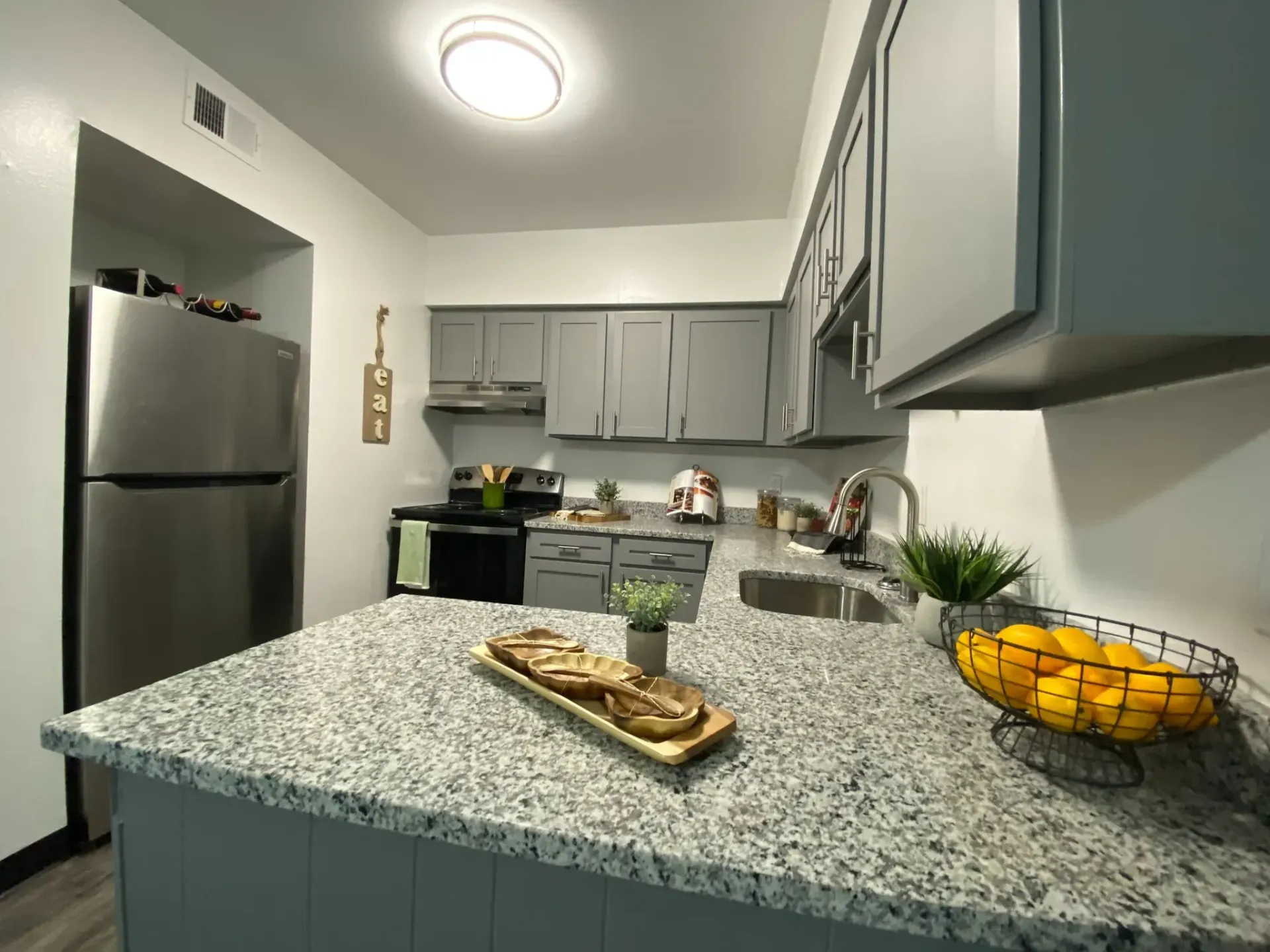 Modern kitchen with stainless steel appliances and granite countertops