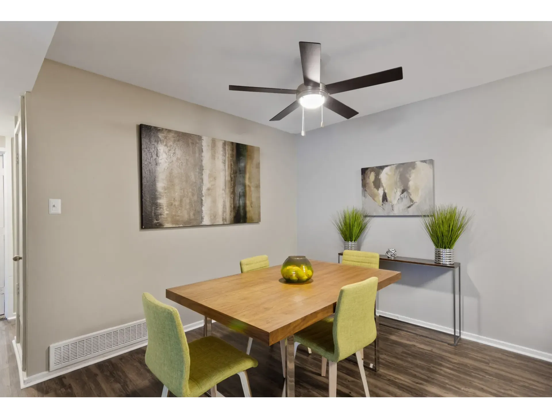 Dining area featuring a wooden table and green chairs