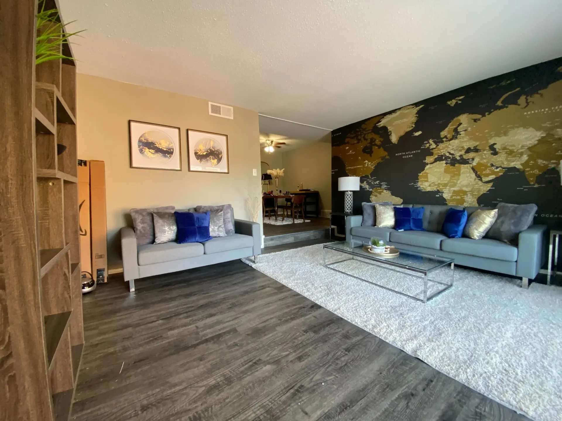 Living room with a modern sofa and decorative wall art.