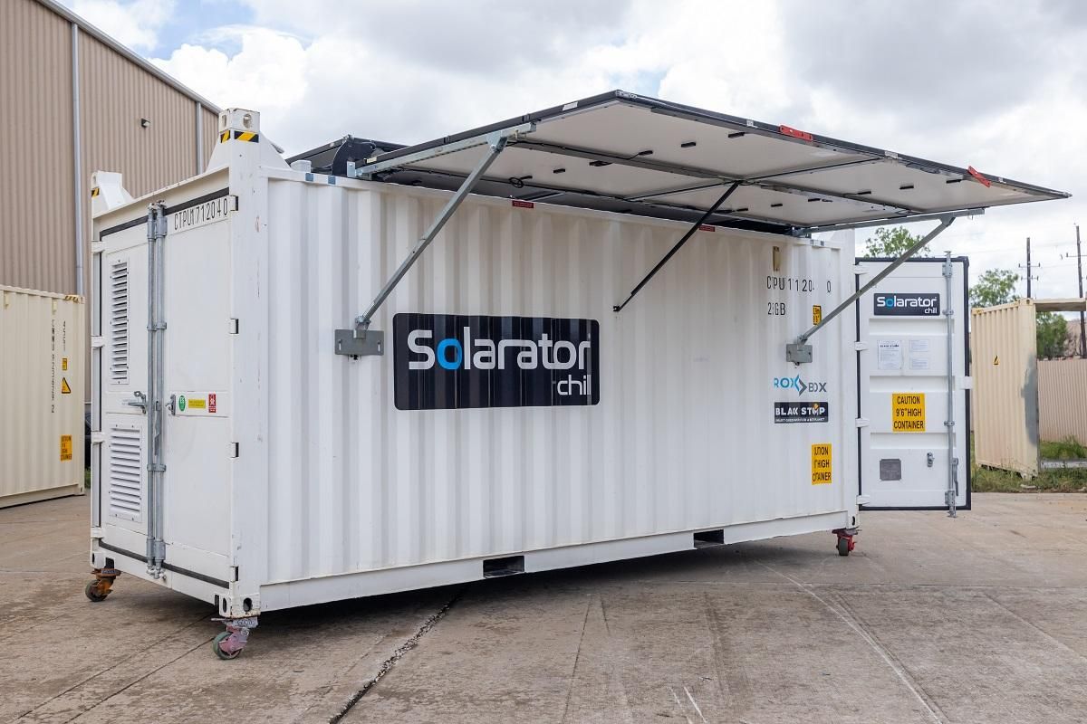 White shipping container with solar panels, labeled 