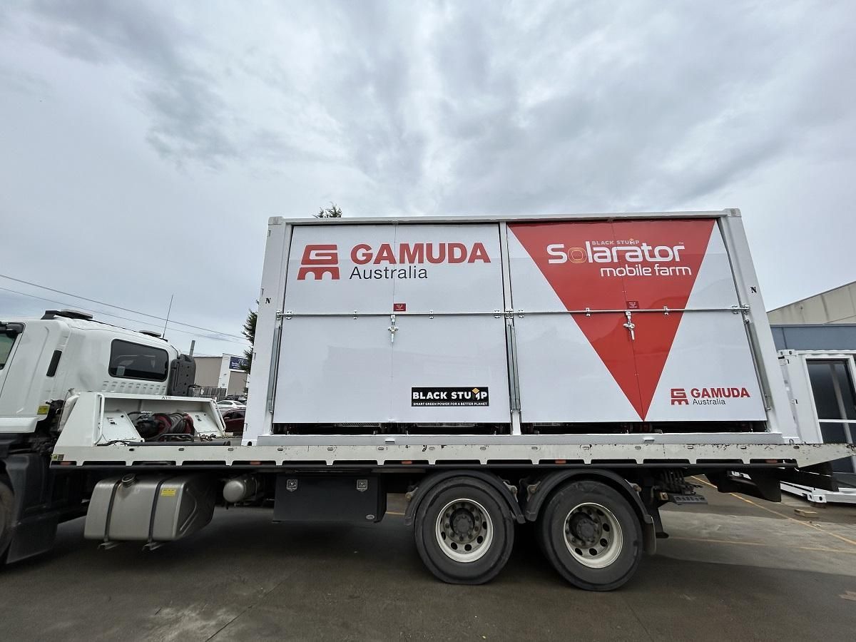 Truck carrying a large white container.