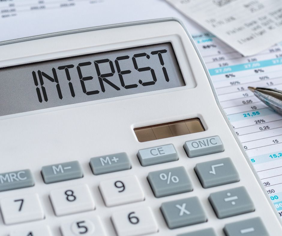 A calculator with the word interest on the screen