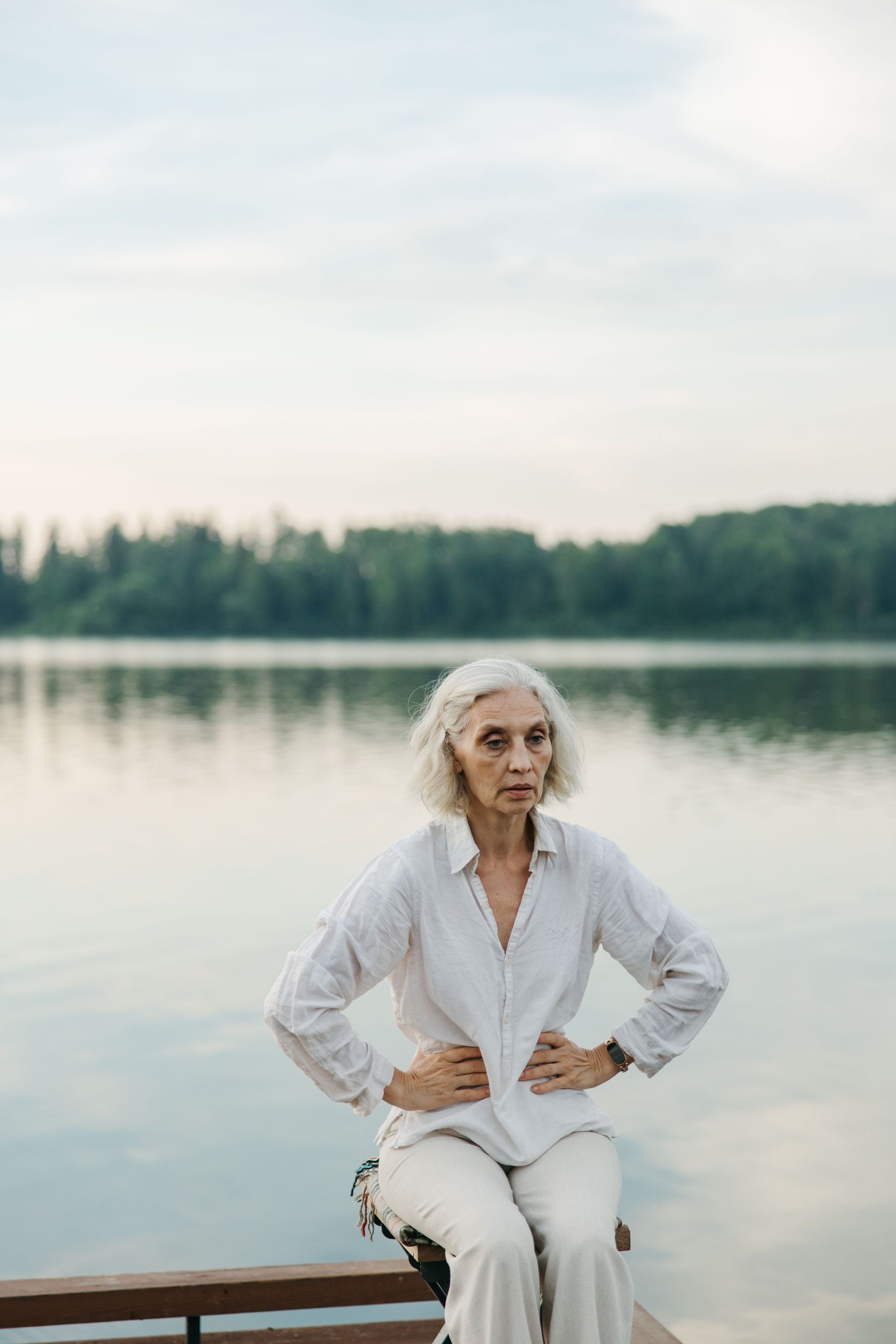Older woman sitting by the water