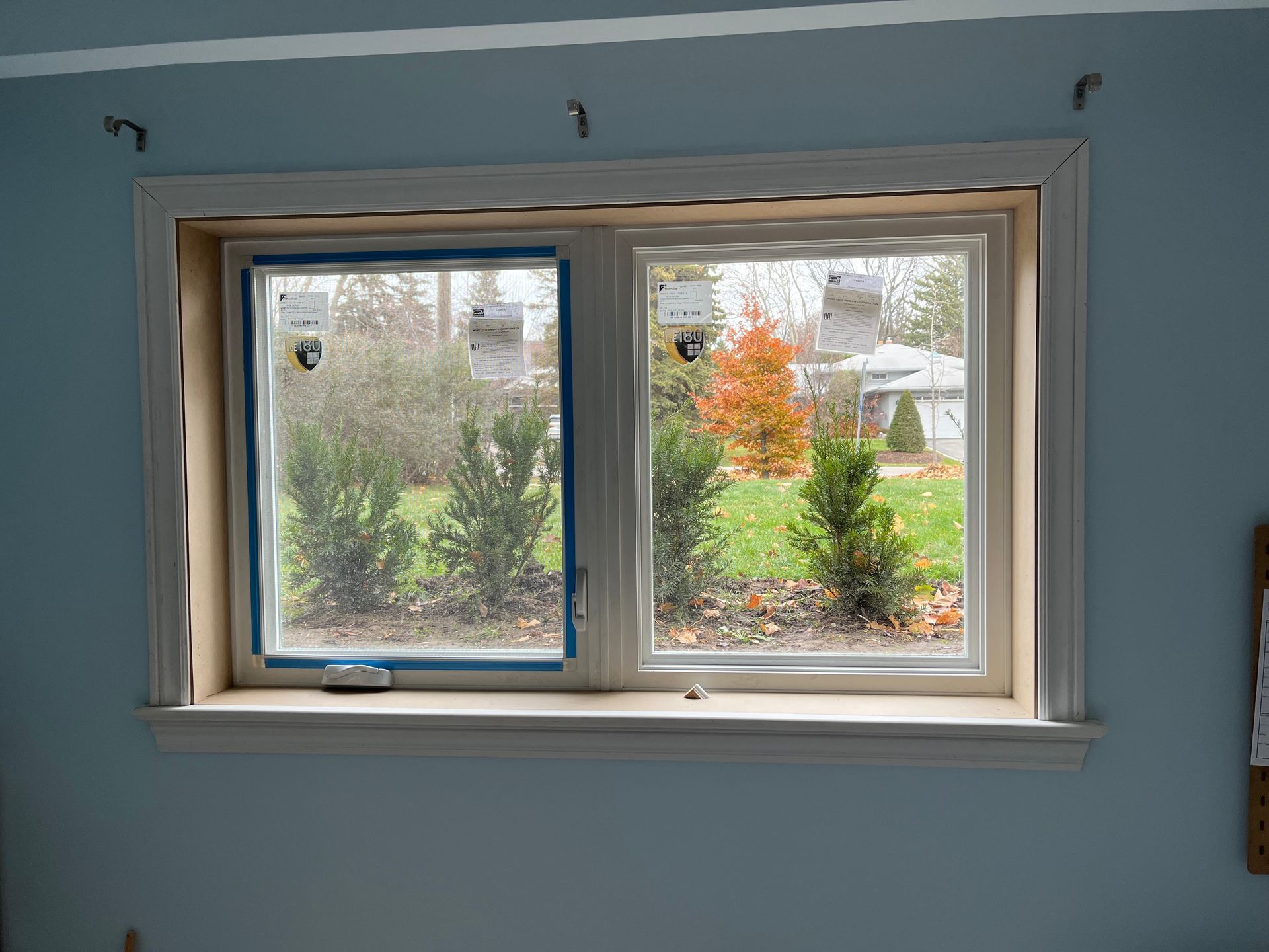 A window in a room with a blue tape on it