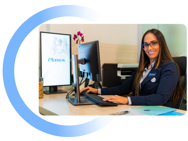 Mulher sentada à mesa usando um computador em um escritório iluminado com uma sobreposição gráfica circular azul.