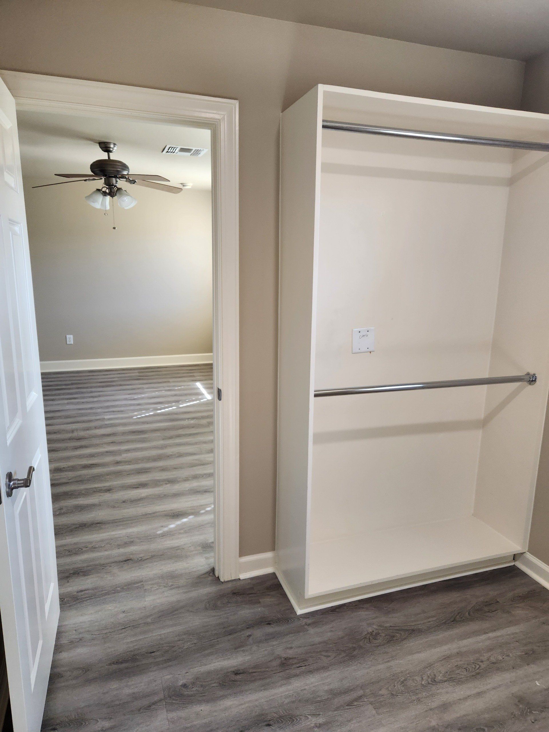 Closet with grey flooring