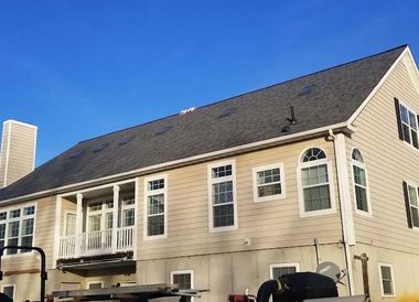 Roofer installing asphalt shingle roof