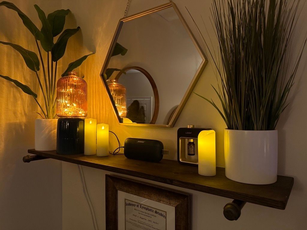 Spa massage table with warm candles and incense in a softly lit room Spa massage table with warm candles and incense in a softly lit room