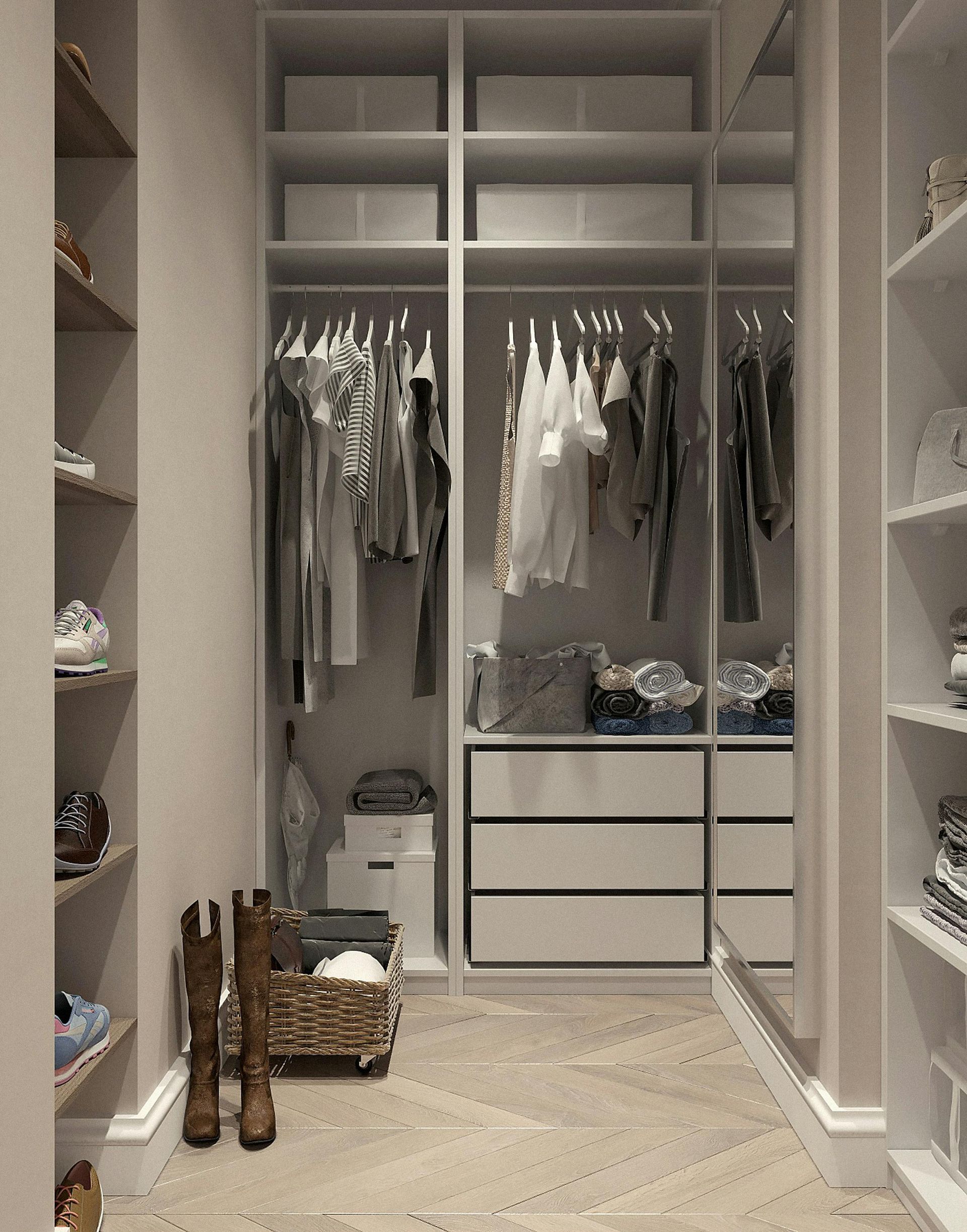 Walk-in closet with shelves and hanging clothes. Boots and storage basket in the foreground. Neutral tones.