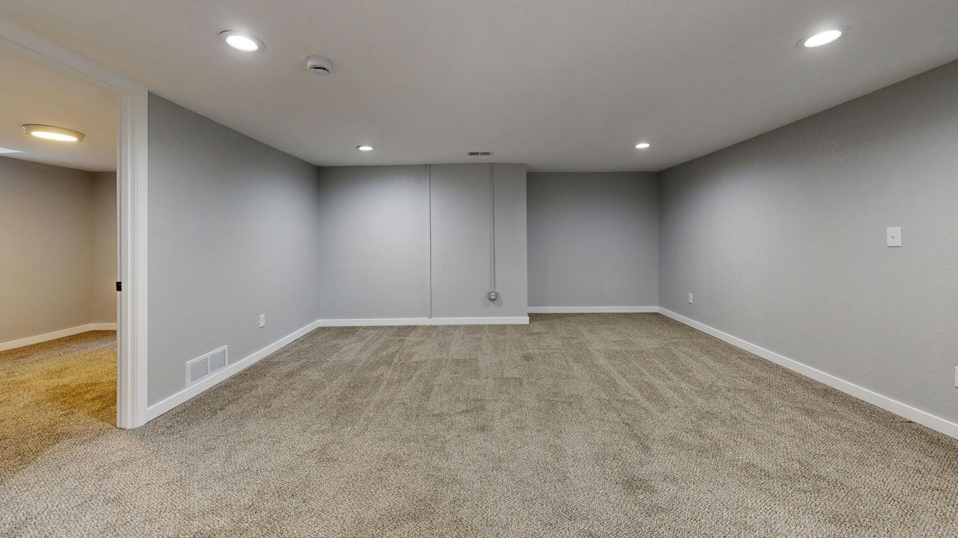 Modern kitchen with gray cabinets, white countertops, stainless steel appliances, and a wood ceiling.