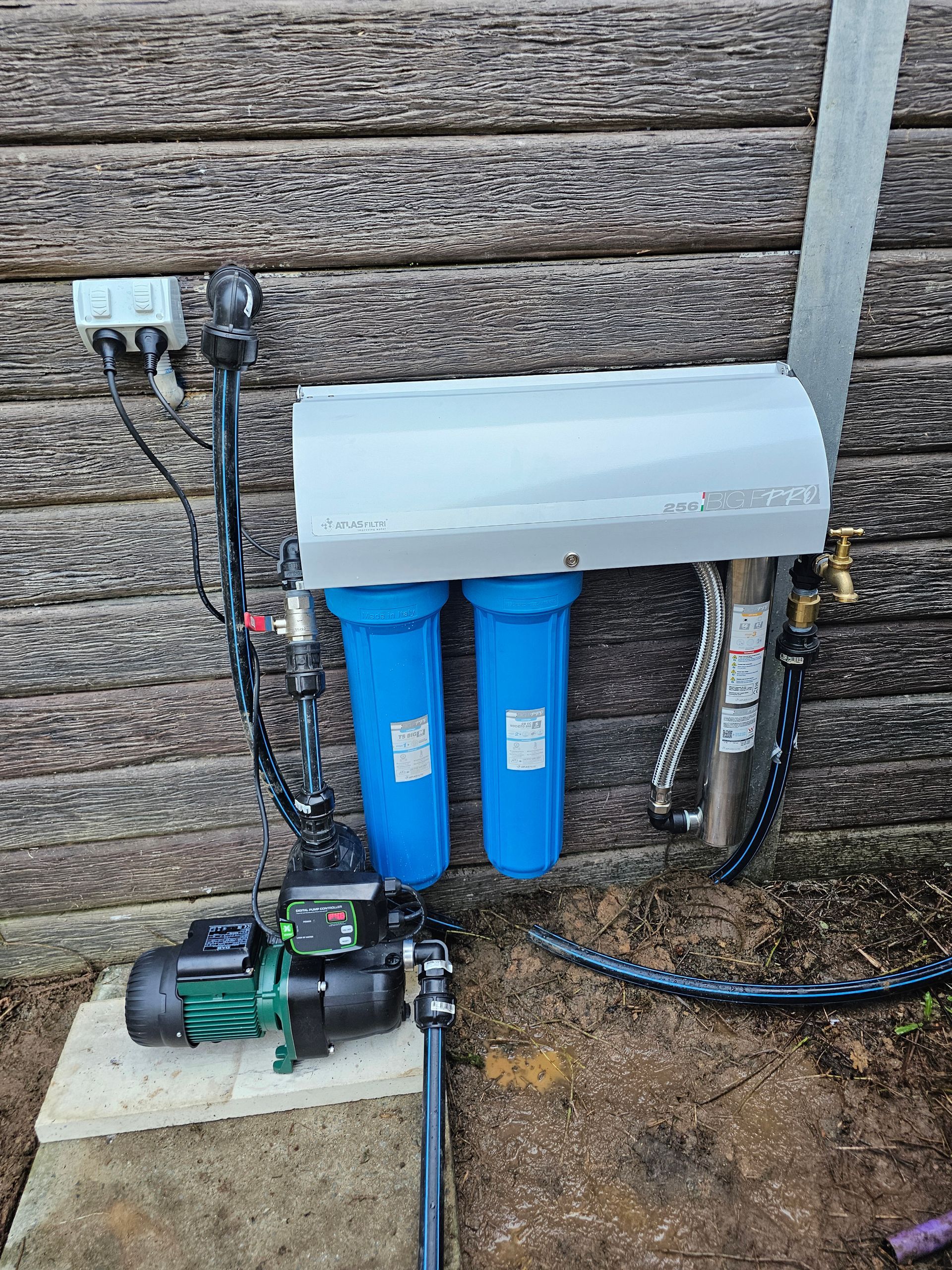 A Man Is Maintaining A Water Pump— Jobec Pumps & Irrigation In Murwillumbah, NSW