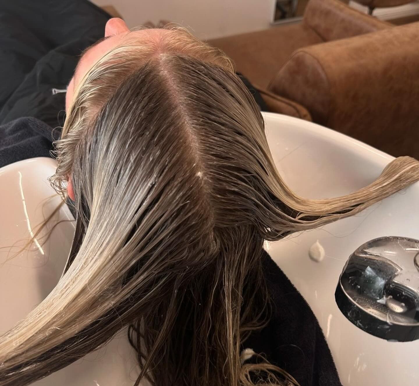 Person Getting Their Hair Washed at A Salon Sink — Pose Hair Design in Orange, NSW