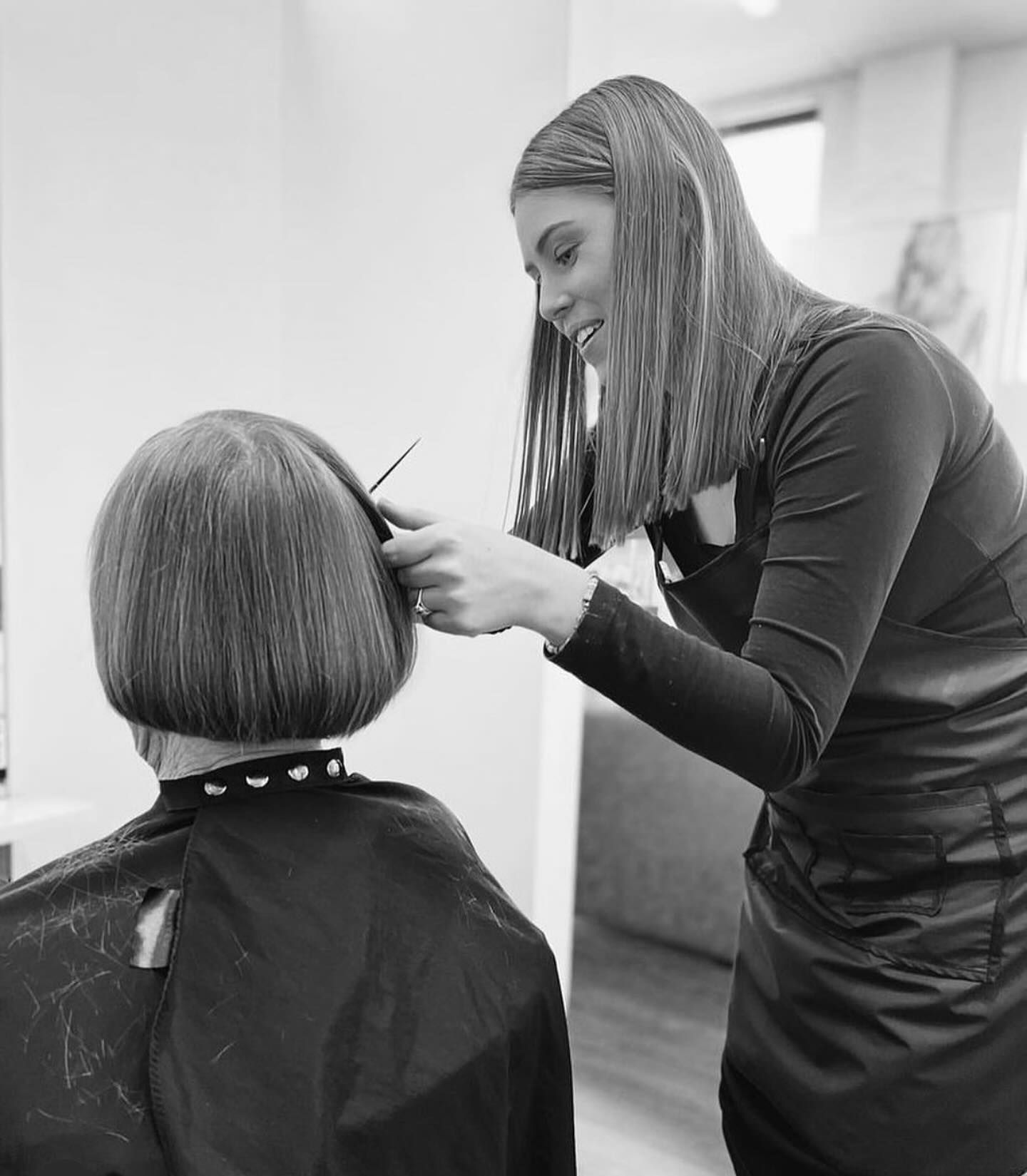 Hairdresser styling a seated client's short hair in a salon — Pose Hair Design in Orange, NSW