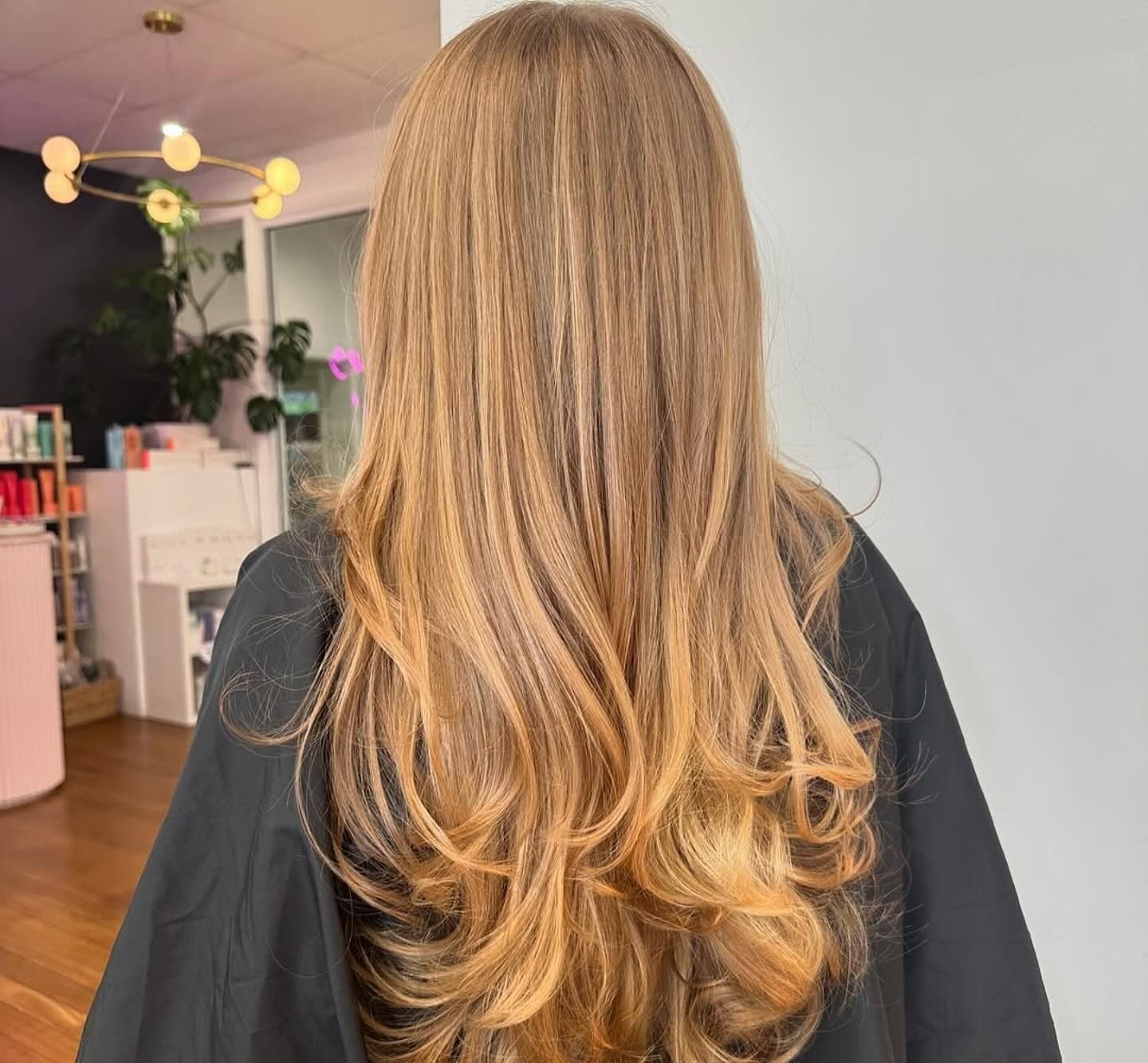 Back View of Long, Layered Blonde Hair in A Salon Interior — Pose Hair Design in Orange, NSW