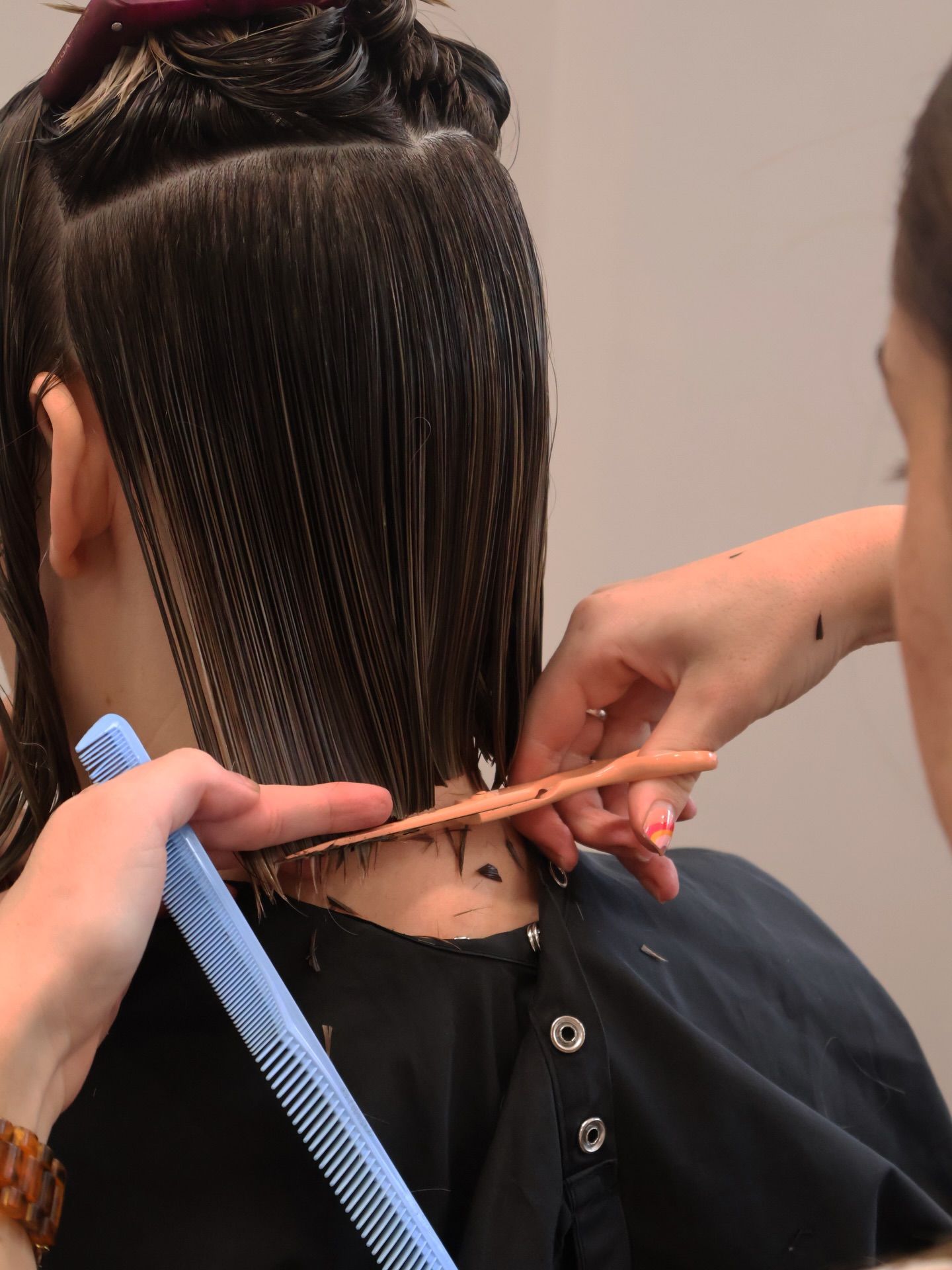 People Getting Their Hair Styled in A Salon, with Mirrors and A Row of Styling Stations — Pose Hair Design in Orange, NSW