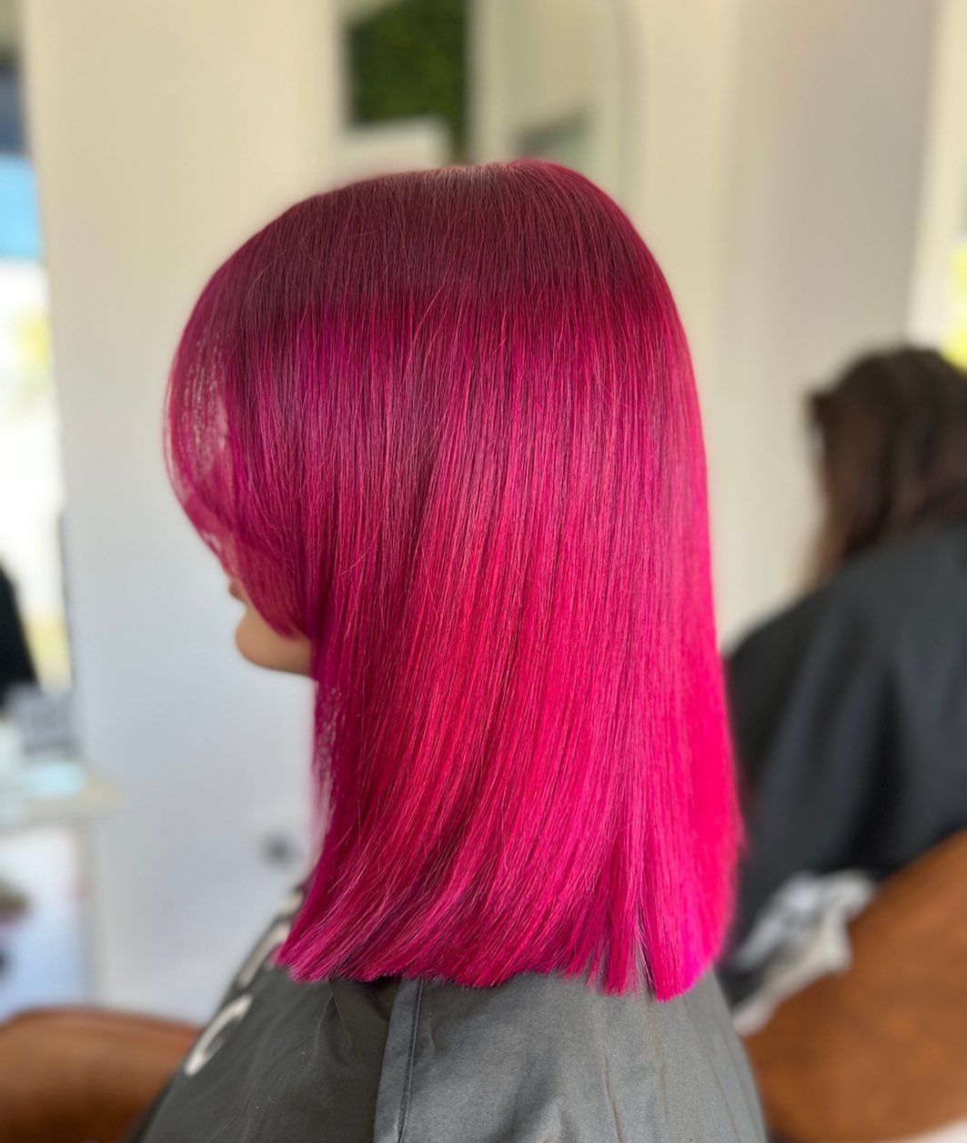 Bright Pink Bob Haircut Shown in Profile at A Salon — Pose Hair Design in Orange, NSW