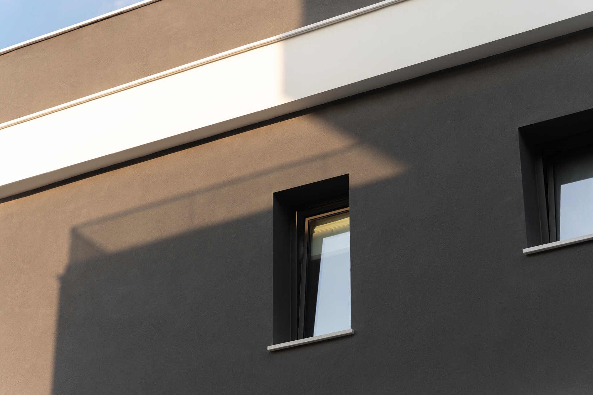A close up of a building with two windows