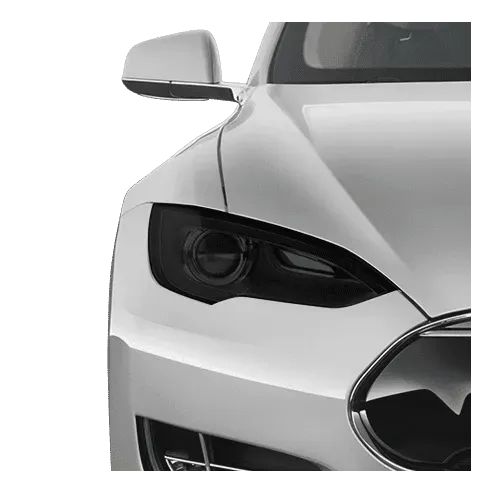Close-up of a silver Tesla's front end, showing headlight, side mirror, and grill.