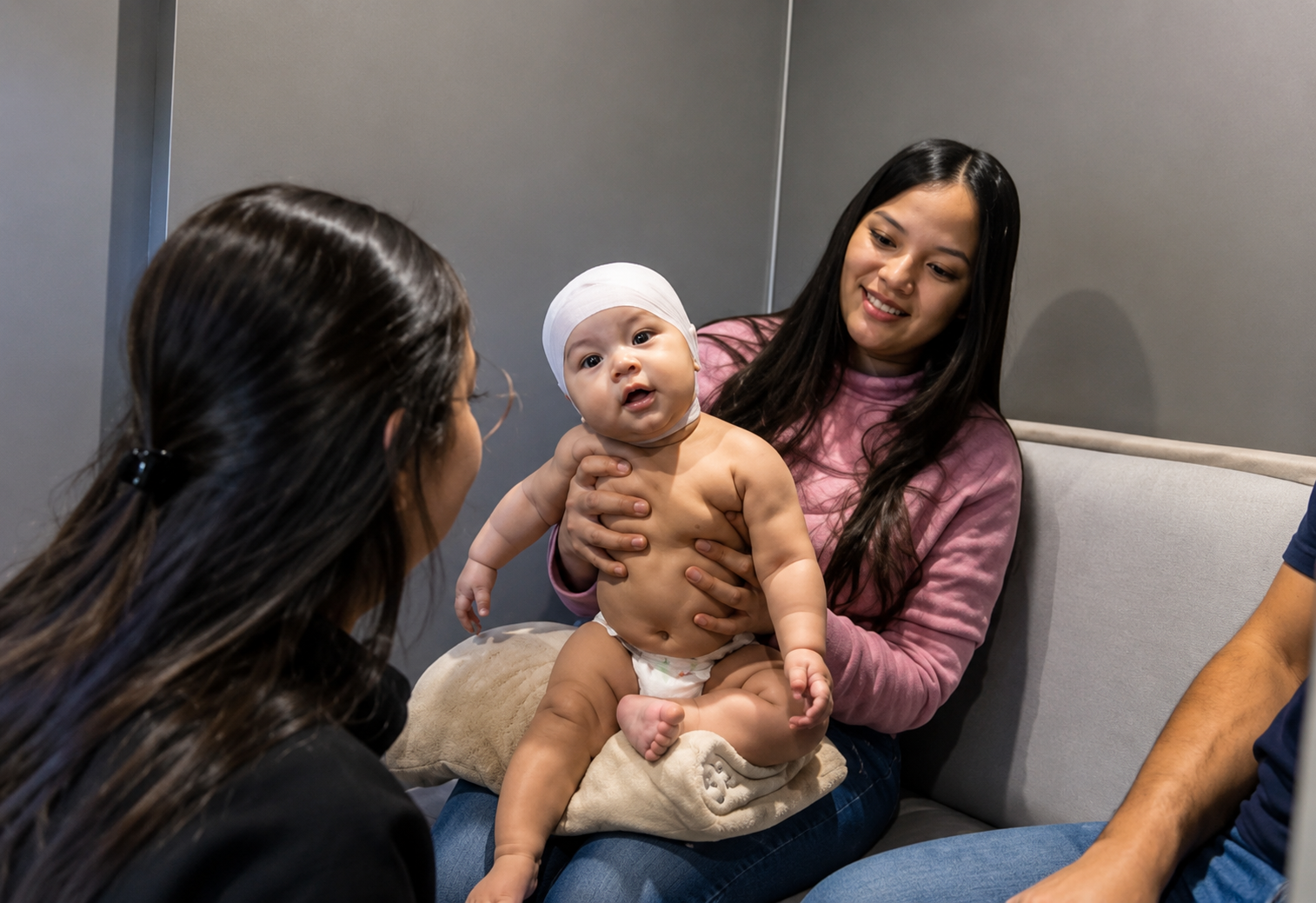 Parent holding baby during Cranial Technologies DOC Band consultation