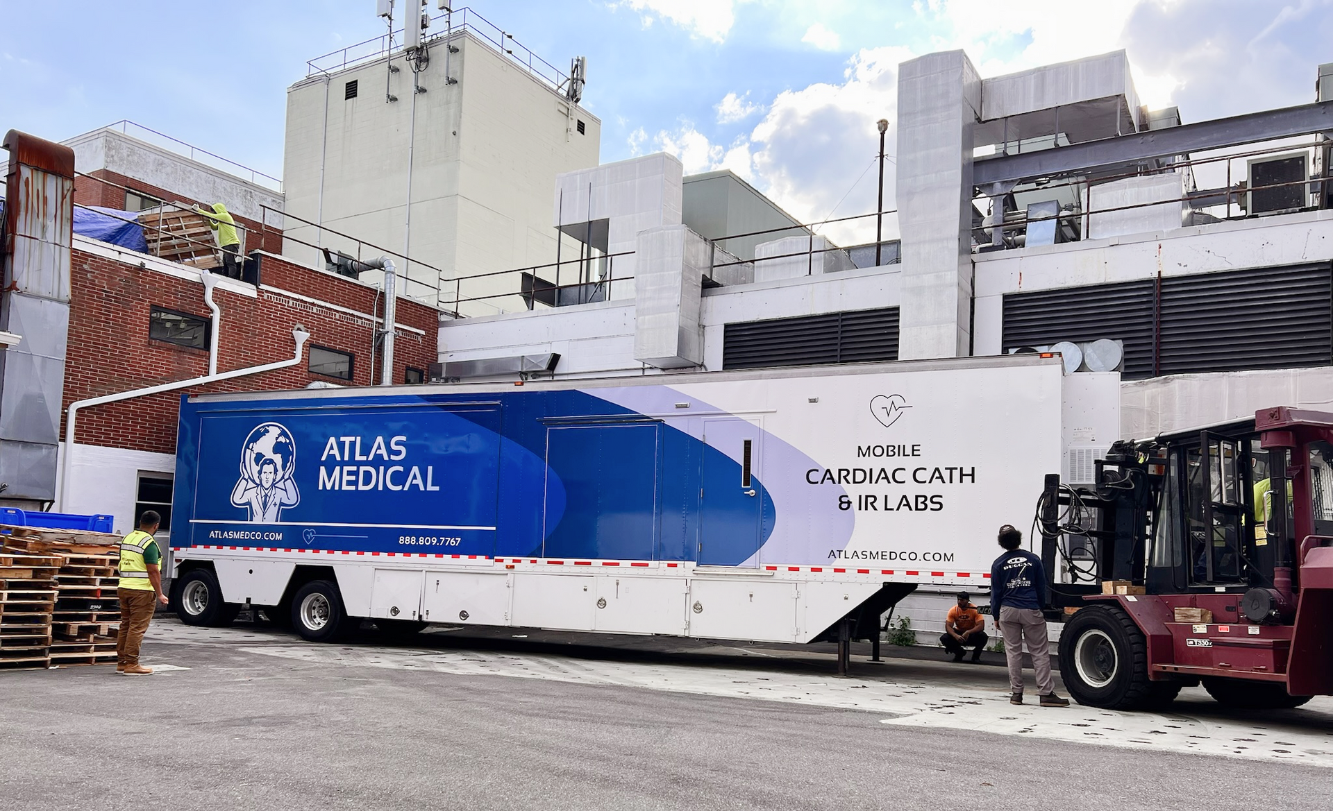 Mobile cath lab truck parked outside a hospital