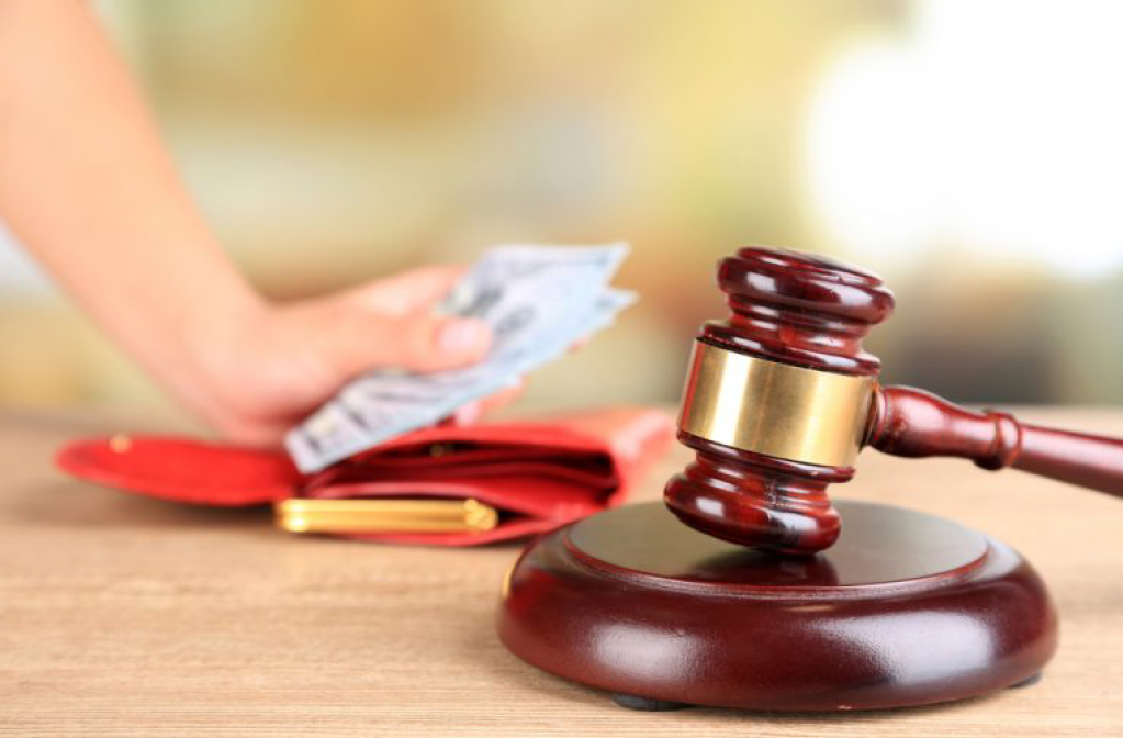 Gavel Next to a Person Holding Money — Florissant, MO — Teague & Associates, LLC Gavel Next to a Person Holding Money — Florissant, MO — Teague & Associates, LLC