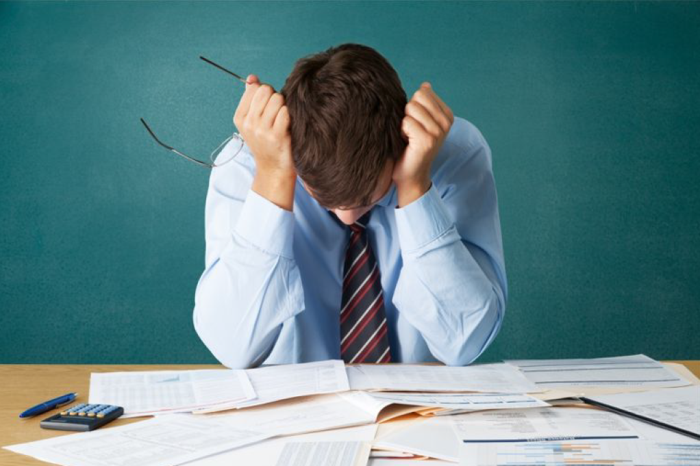 Man Staring at Many Documents — Florissant, MO — Teague & Associates, LLC Man Staring at Many Documents — Florissant, MO — Teague & Associates, LLC