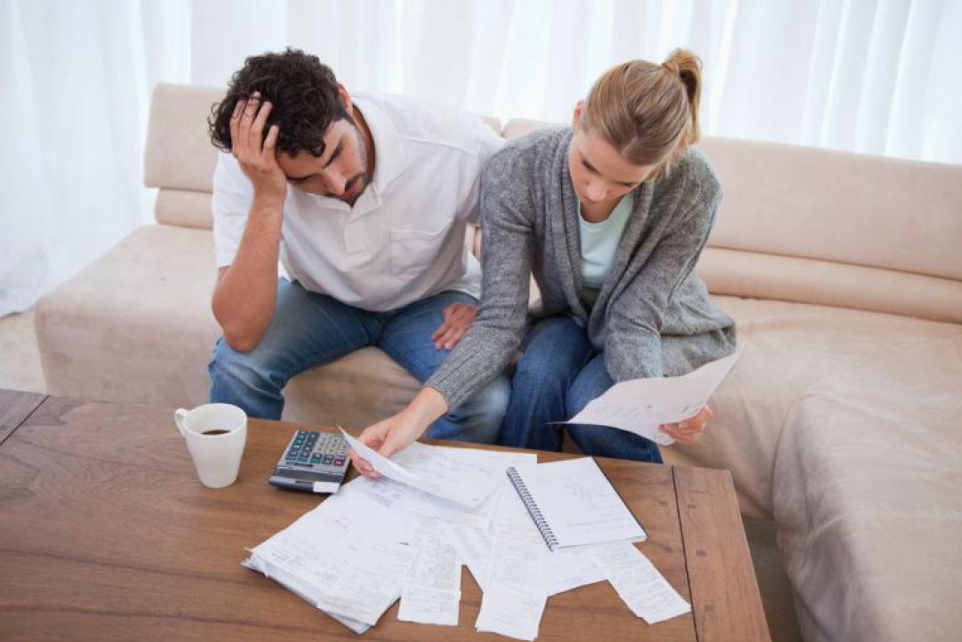 Two People Looking at Their Bills — Florissant, MO — Teague & Associates, LLC Two People Looking at Their Bills — Florissant, MO — Teague & Associates, LLC