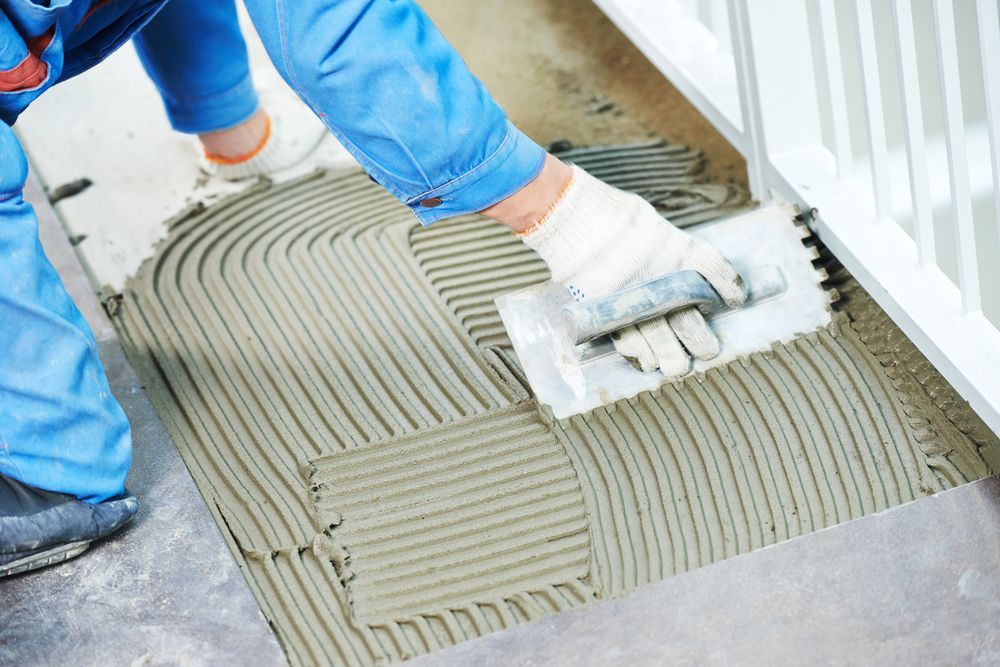 Spread Adhesive for Tile Installation on a Floor — Tropic Tiling in Mareeba, QLD