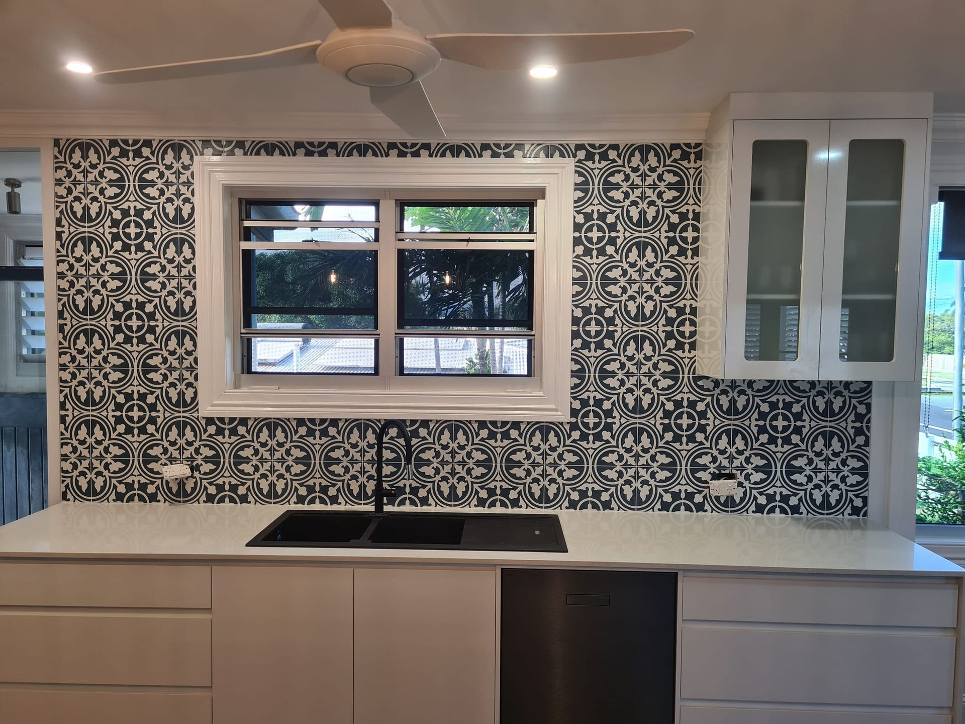 Modern U-shaped Kitchen With Black Cabinets, and White Countertops — Tropic Tiling in Yungaburra, QLD