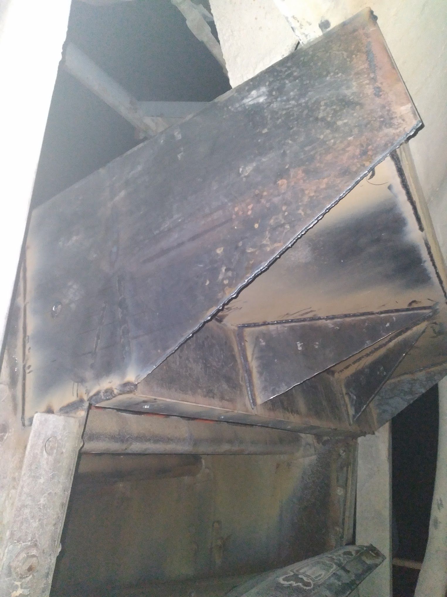 A piece of metal is sitting on top of a wooden table.