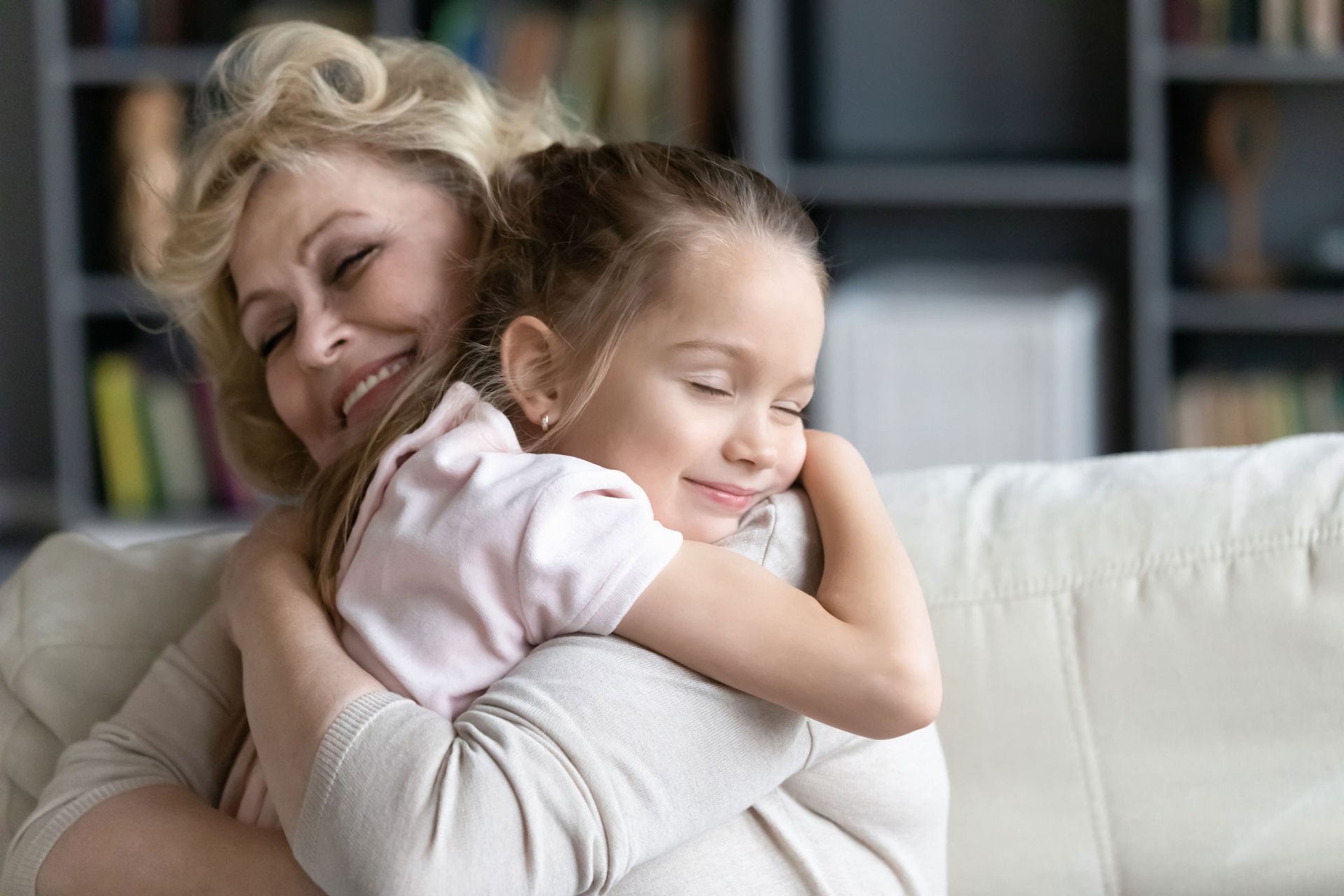 Loving grandmother hugging grandchild, symbolizing support, and care