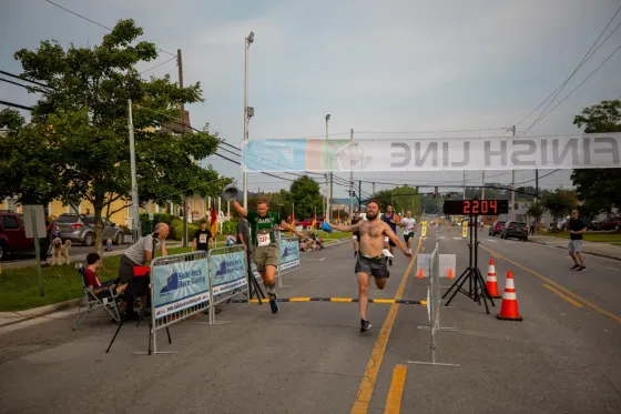 A group of men are running a marathon on a city street.