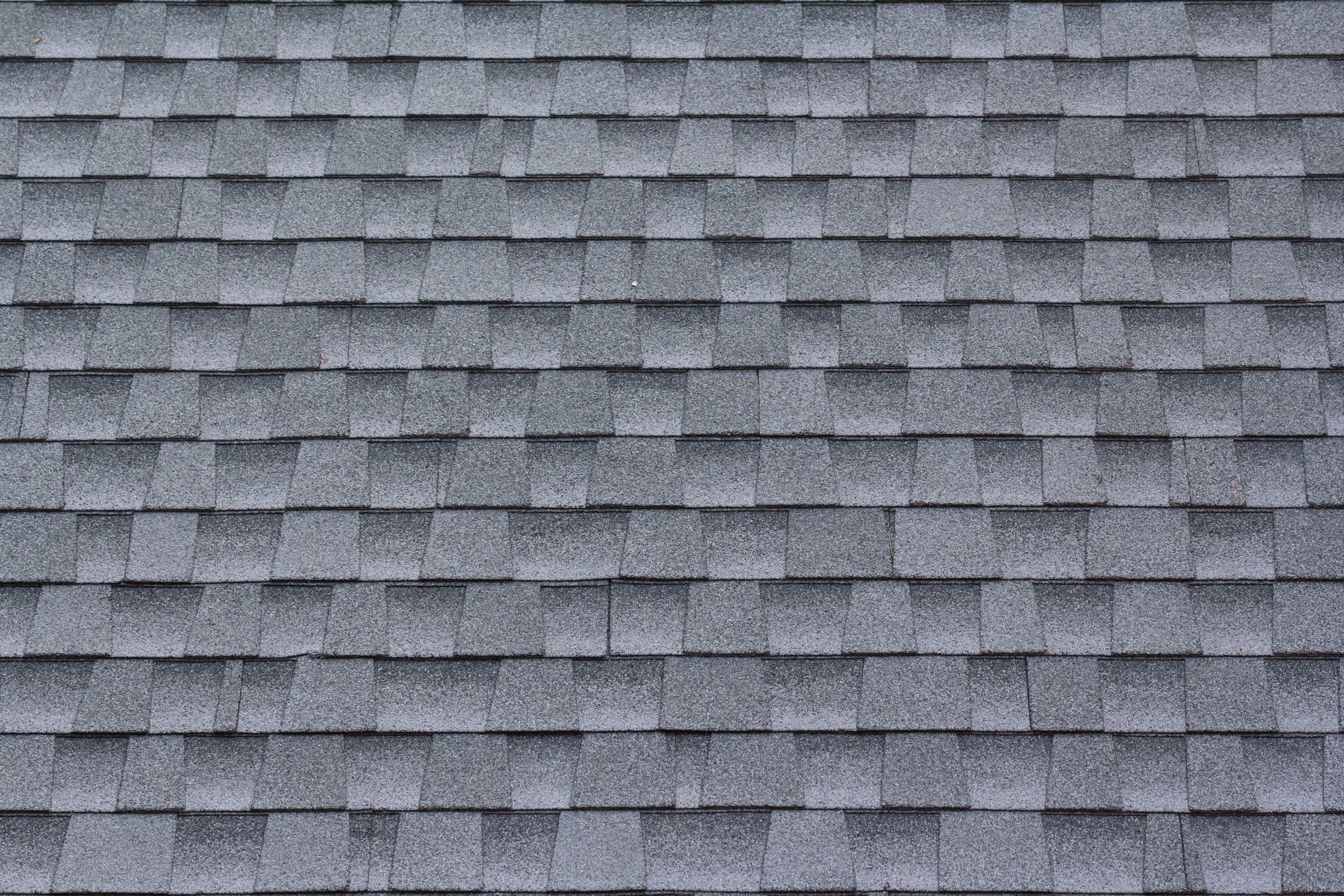 A close up of a gray asphalt shingle roof.