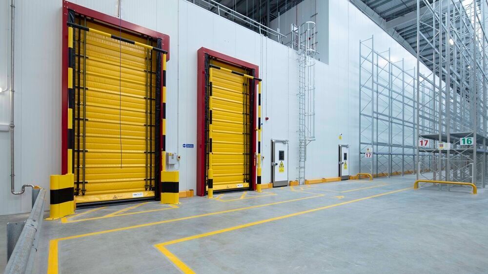 Modern industrial warehouse loading areas, viewed from the side.