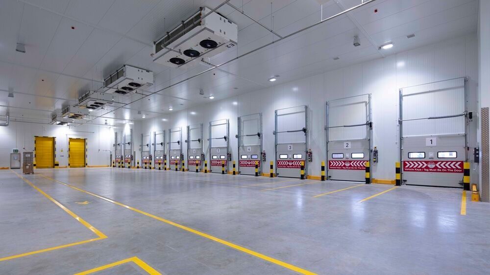 Modern industrial warehouse loading areas, viewed from the side.