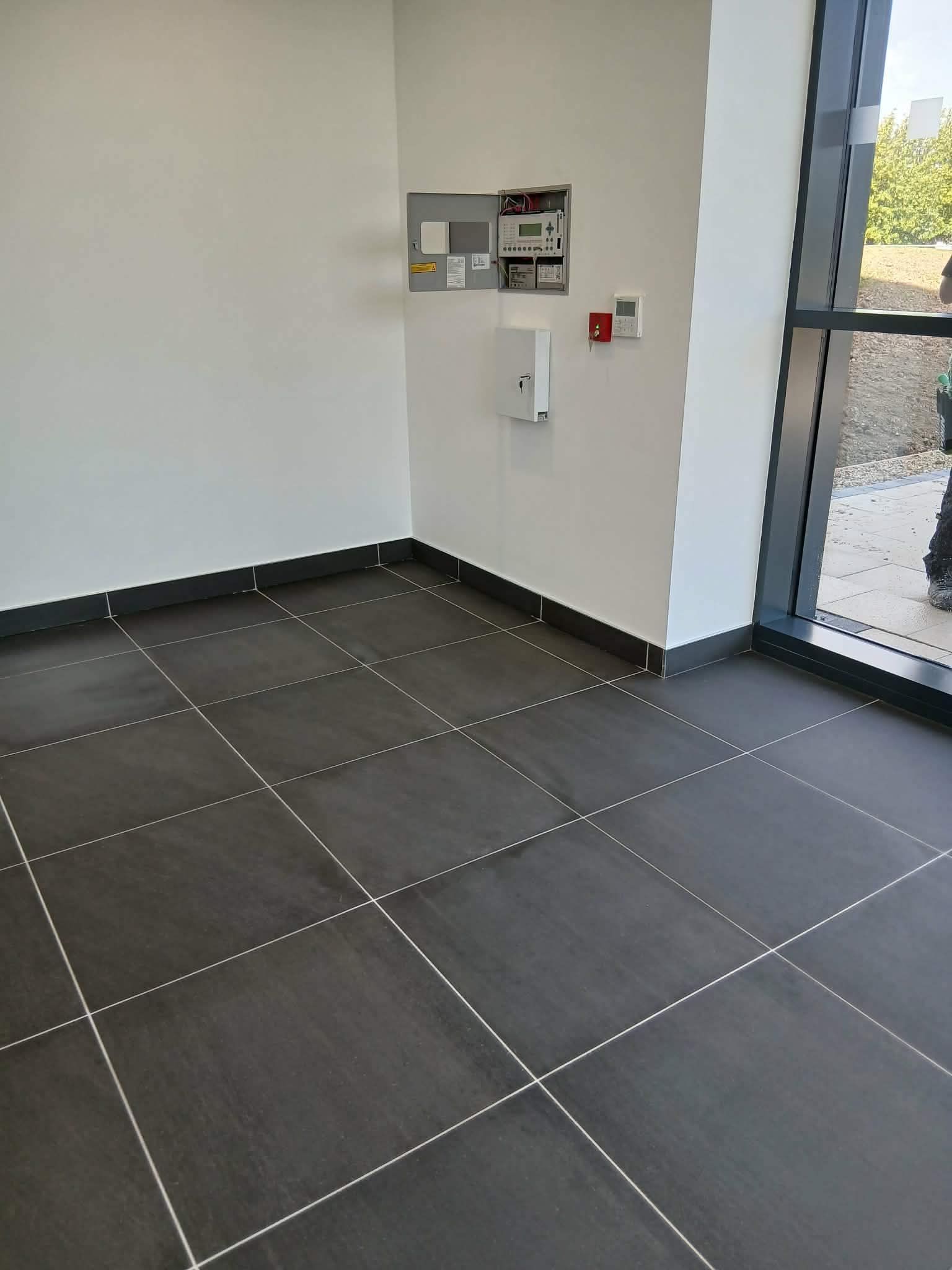 Clean internal entrance area with tiled floor and large window 