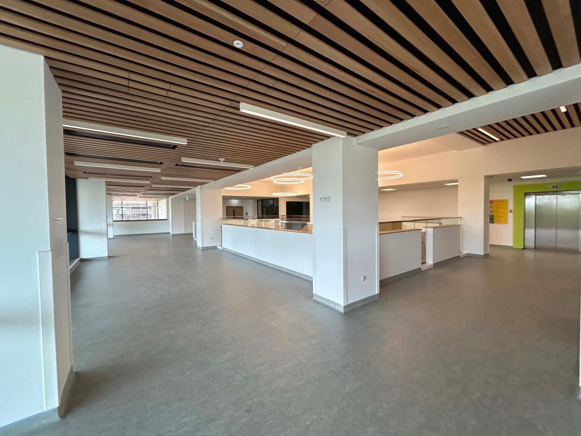 Open hospital interior with feature ceiling and natural light