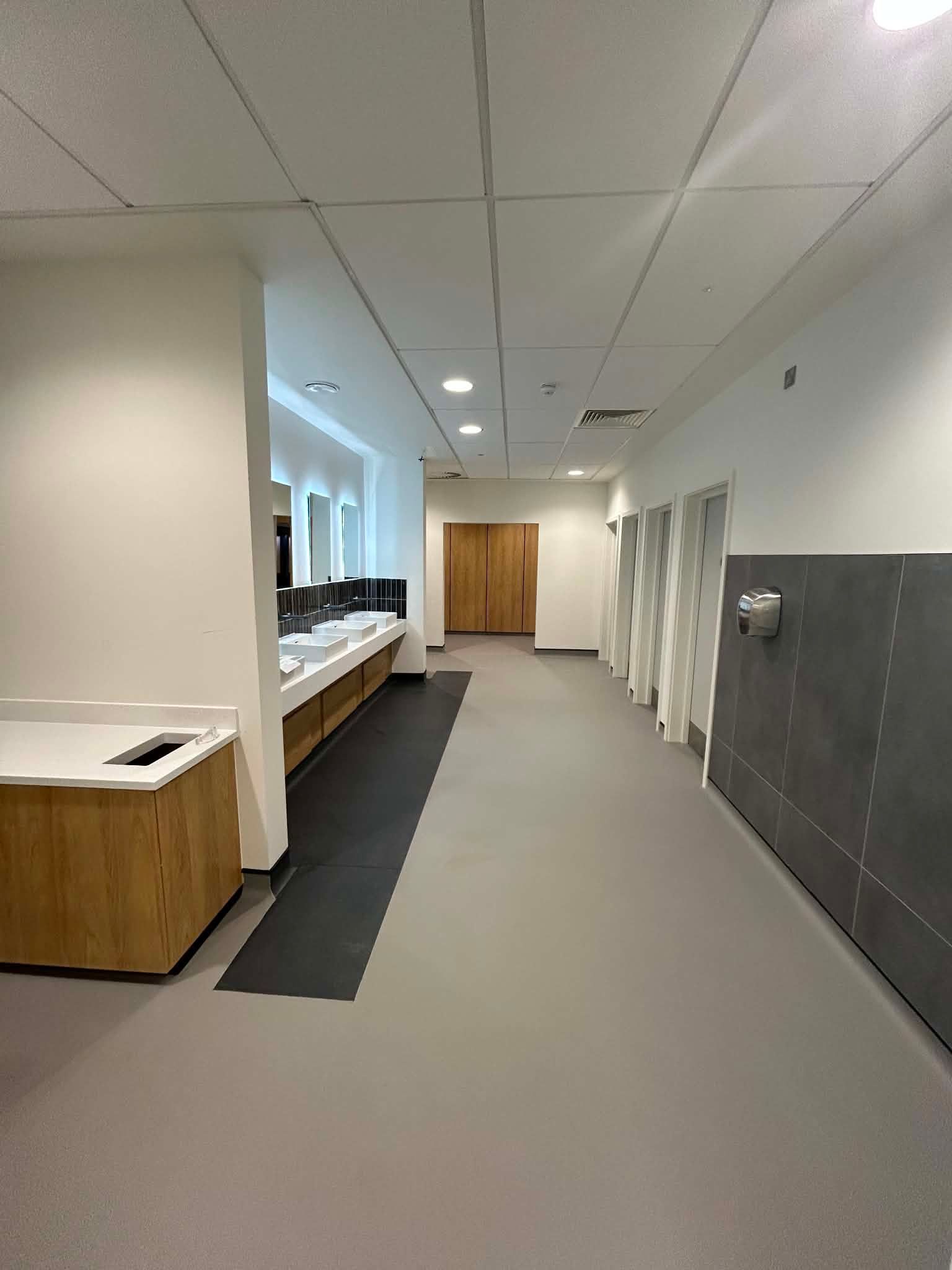 Clean internal corridor with changing facilities at Newcastle United Training Ground 