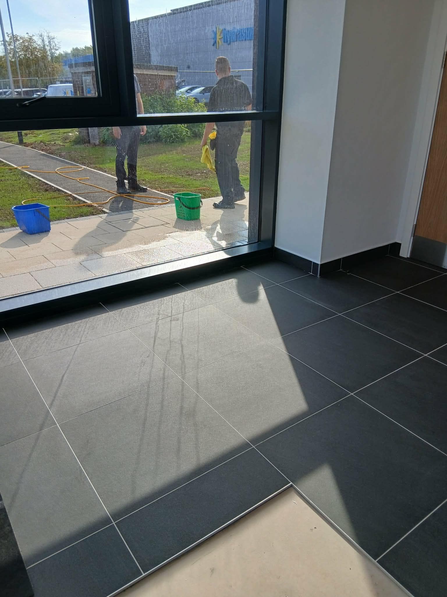 Clean internal entrance area with tiled floor and large window 