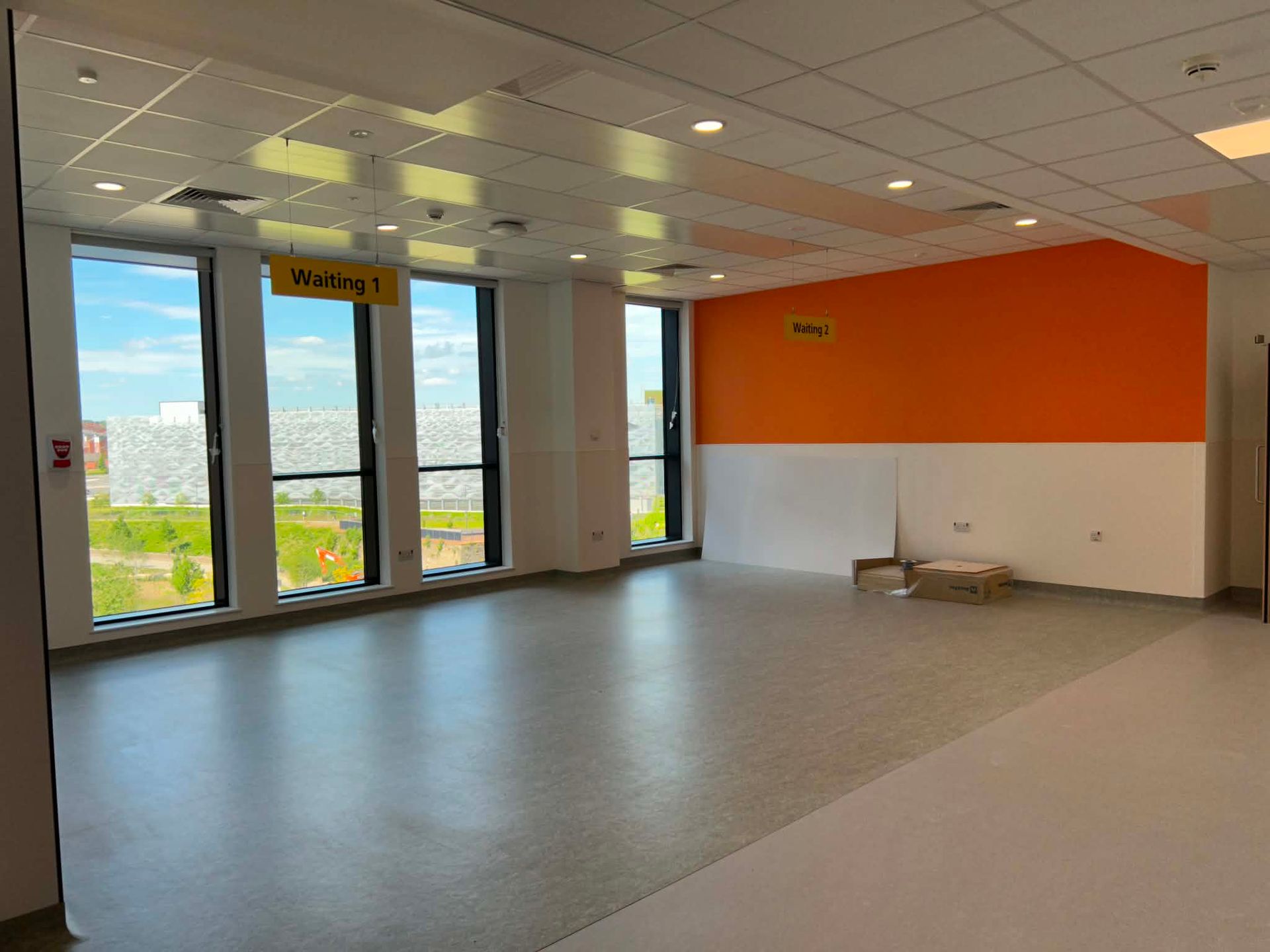 Patient waiting area with large windows overlooking the grounds 