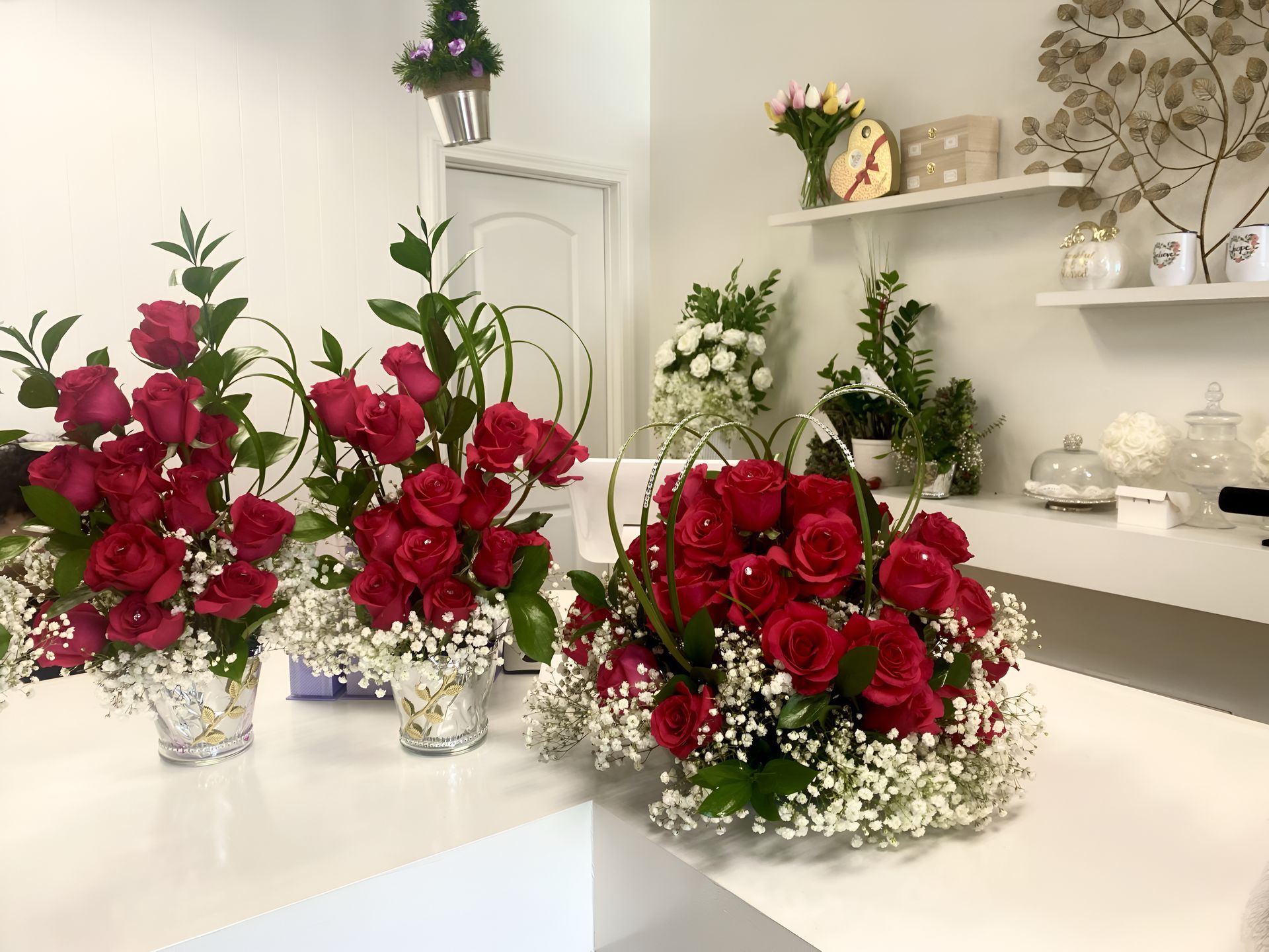  Luxury Red rose arrangements with baby's breath on a white counter in a flower shop perfect for Valentines