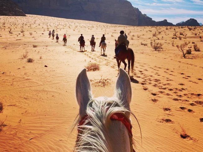 Horse riding through the stunning desert landscape of Wadi Rum, Jordan