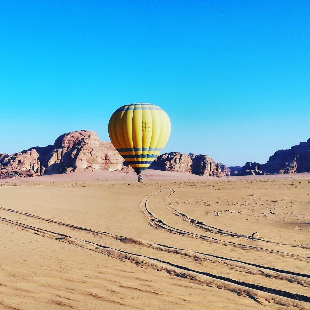 Hot air balloon flying over the stunning desert landscape of Wadi Rum, Jordan
