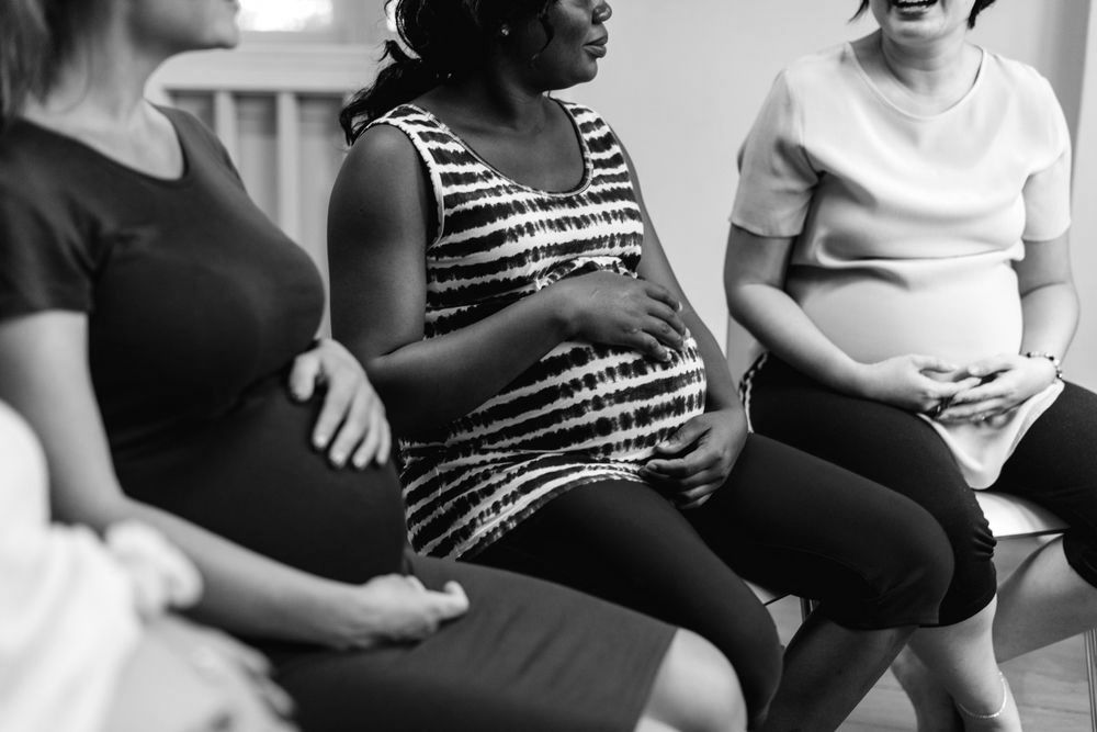 People seated in a circle during a group discussion or support session