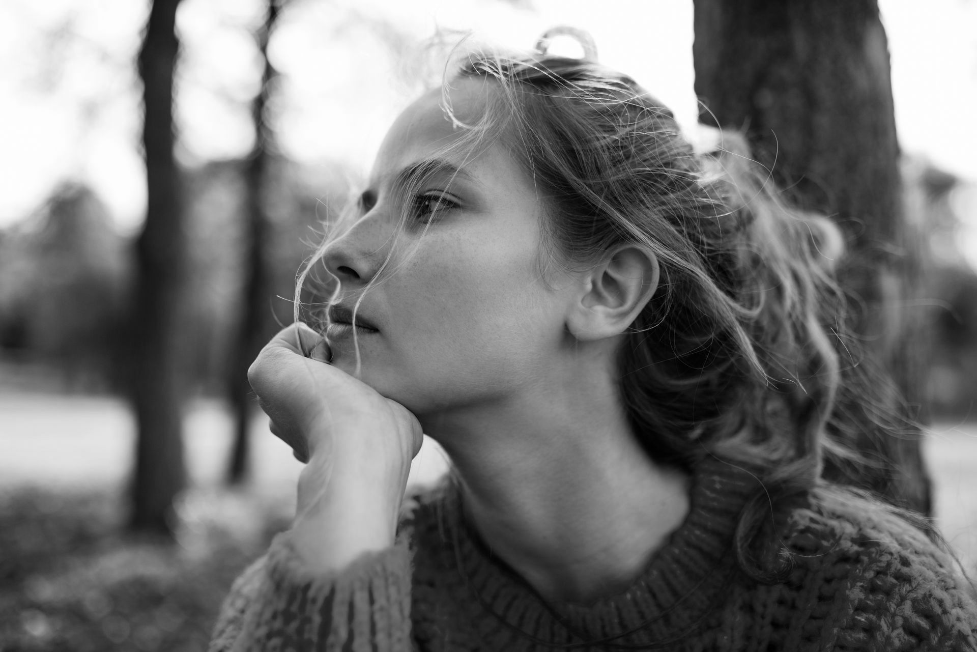 A woman looking pensive off into the distance.