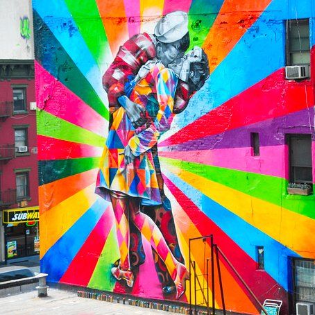 A colorful mural of a man and woman kissing on a wall