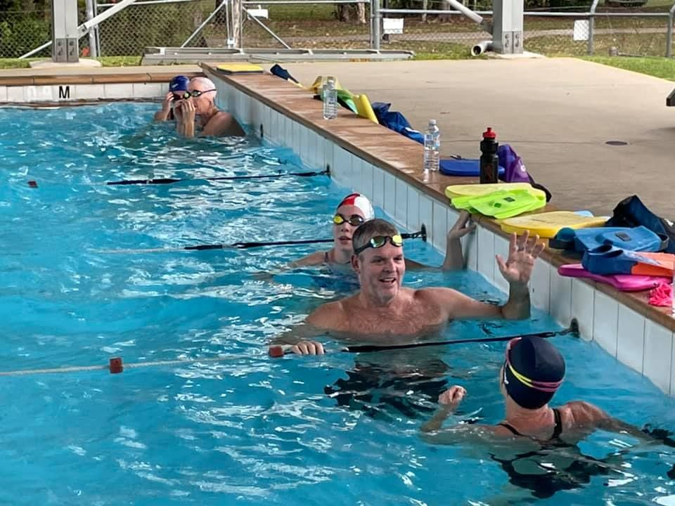 Swimmers in a Pool, Some Using Kickboards, Swimming Laps — Cannonvale Swim Centre In Cannonvale, QLD