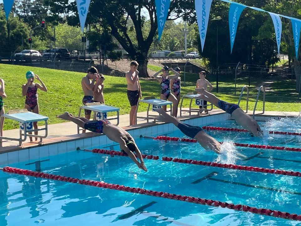 People In A Pool, Exercising Under A Blue Roof With A Mountain Backdrop — Cannonvale Swim Centre In Cannonvale, QLD