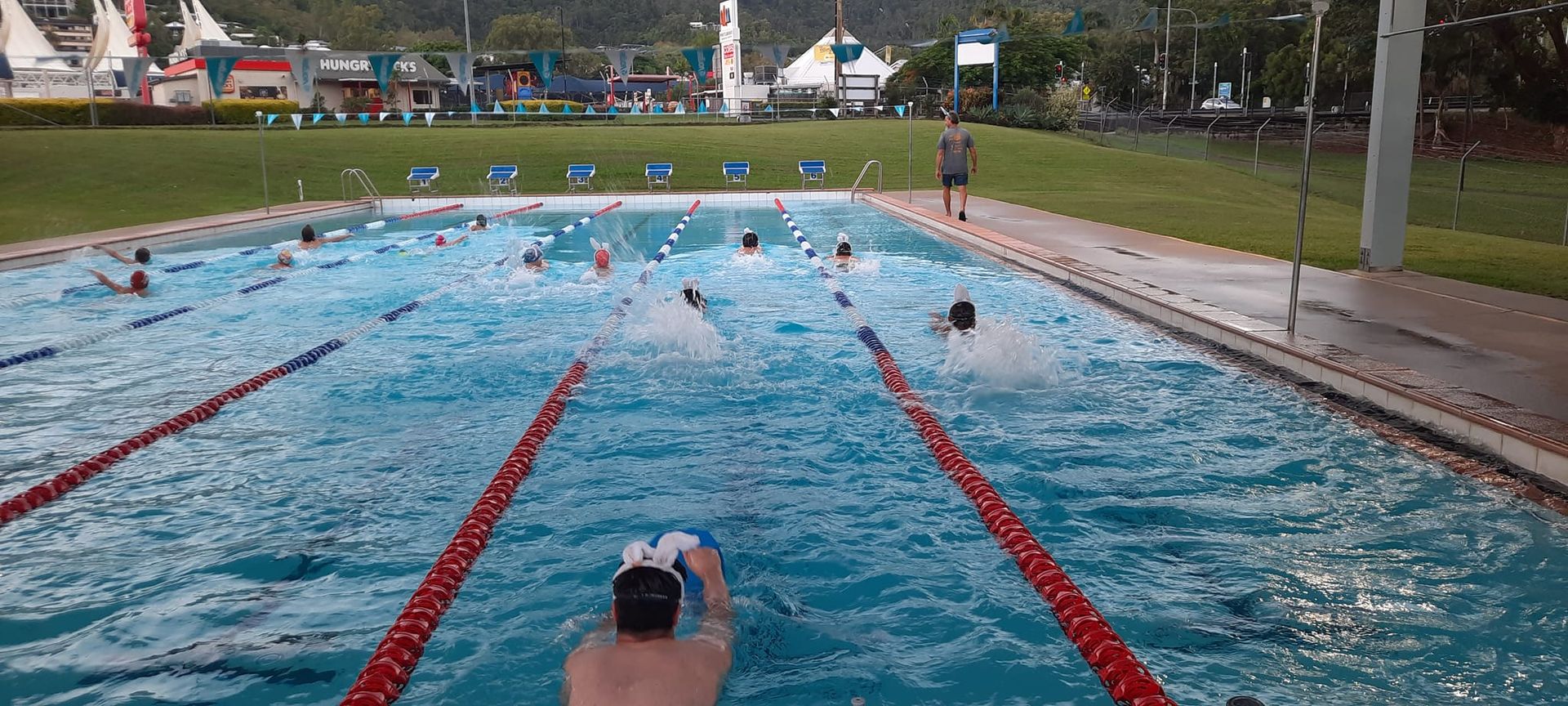 People In A Pool, Exercising Under A Blue Roof With A Mountain Backdrop — Cannonvale Swim Centre In Cannonvale, QLD