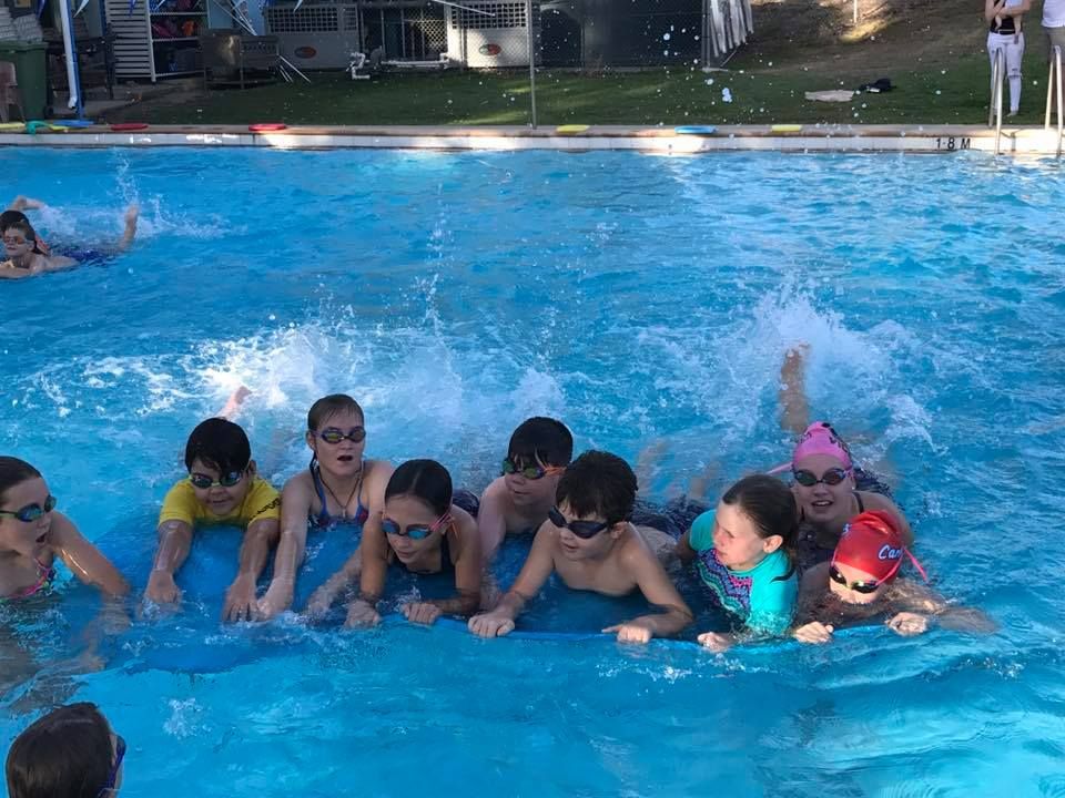 A Group of Children Wearing Swimming Goggles and Caps — Cannonvale Swim Centre In Cannonvale, QLD